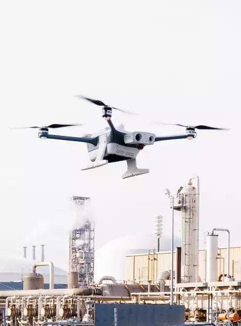 A drone flies with the Koch plant in the background